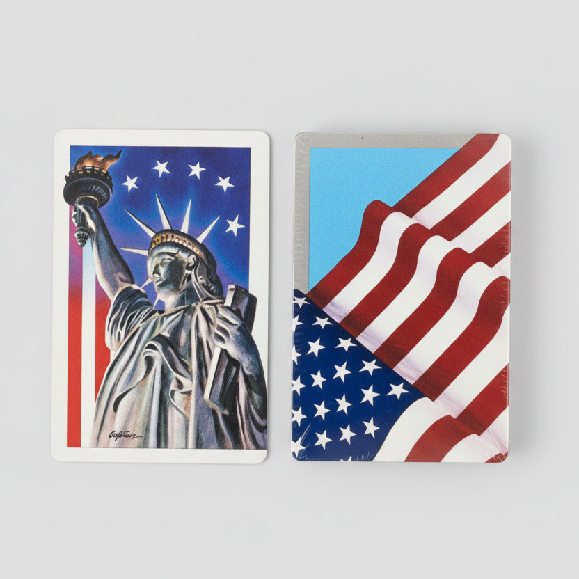 Two Hoyle playing cards featuring the Statue of Liberty and an American flag 