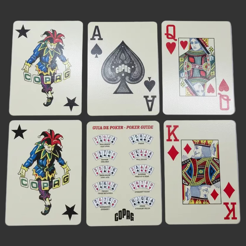 Close-up of six Copag Vintage Collection cards, including jokers, court cards, a custom Ace of Spades, and poker guide card.