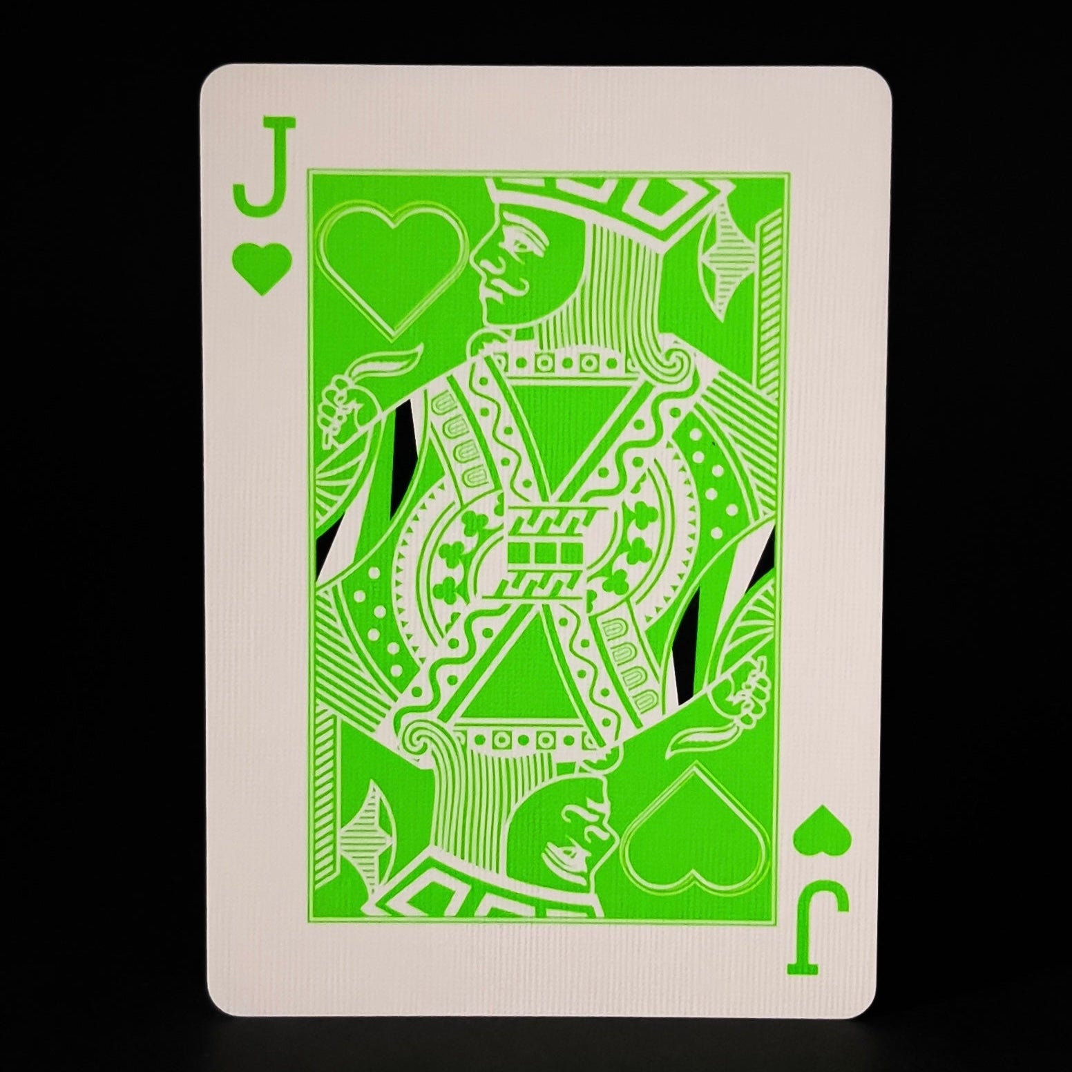 Green Descendents playing card with a jack of hearts design on a black background