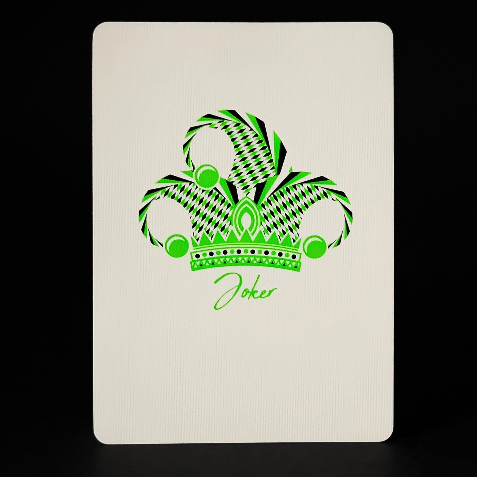 Descendents playing card with green joker design on a white background