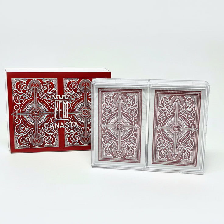 Red and white playing cards with 'EEM Canasta' branding on a white background