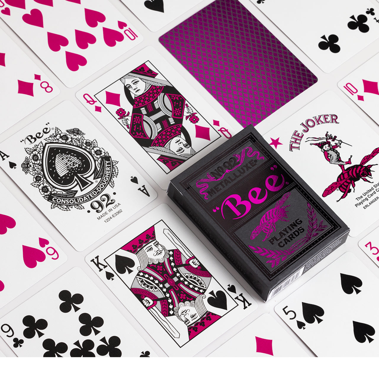 Bee Magenta Metalluxe playing cards with visible suits and 'Bee' branding on a white background
