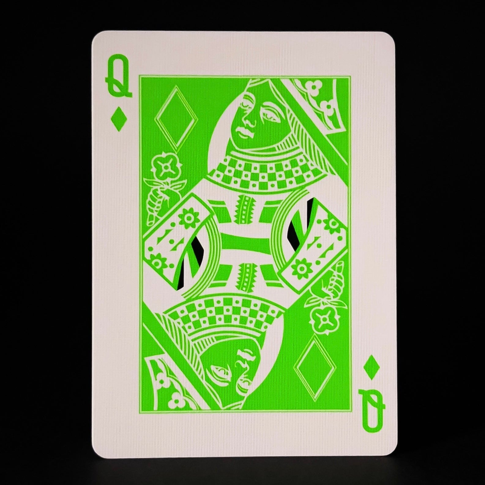 Descendents playing card with green design on a black background