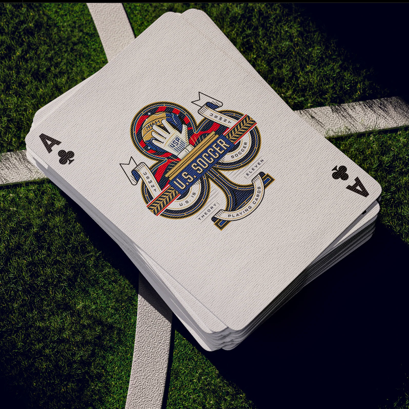 Playing cards with U.S. Soccer logo on a grass background