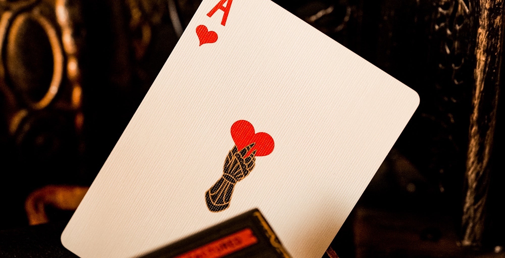 Playing card with Ace of Hearts on a dark background