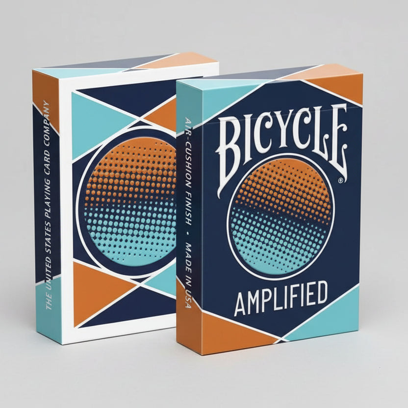 Two boxes of Bicycle Amplified playing cards with blue and orange design.