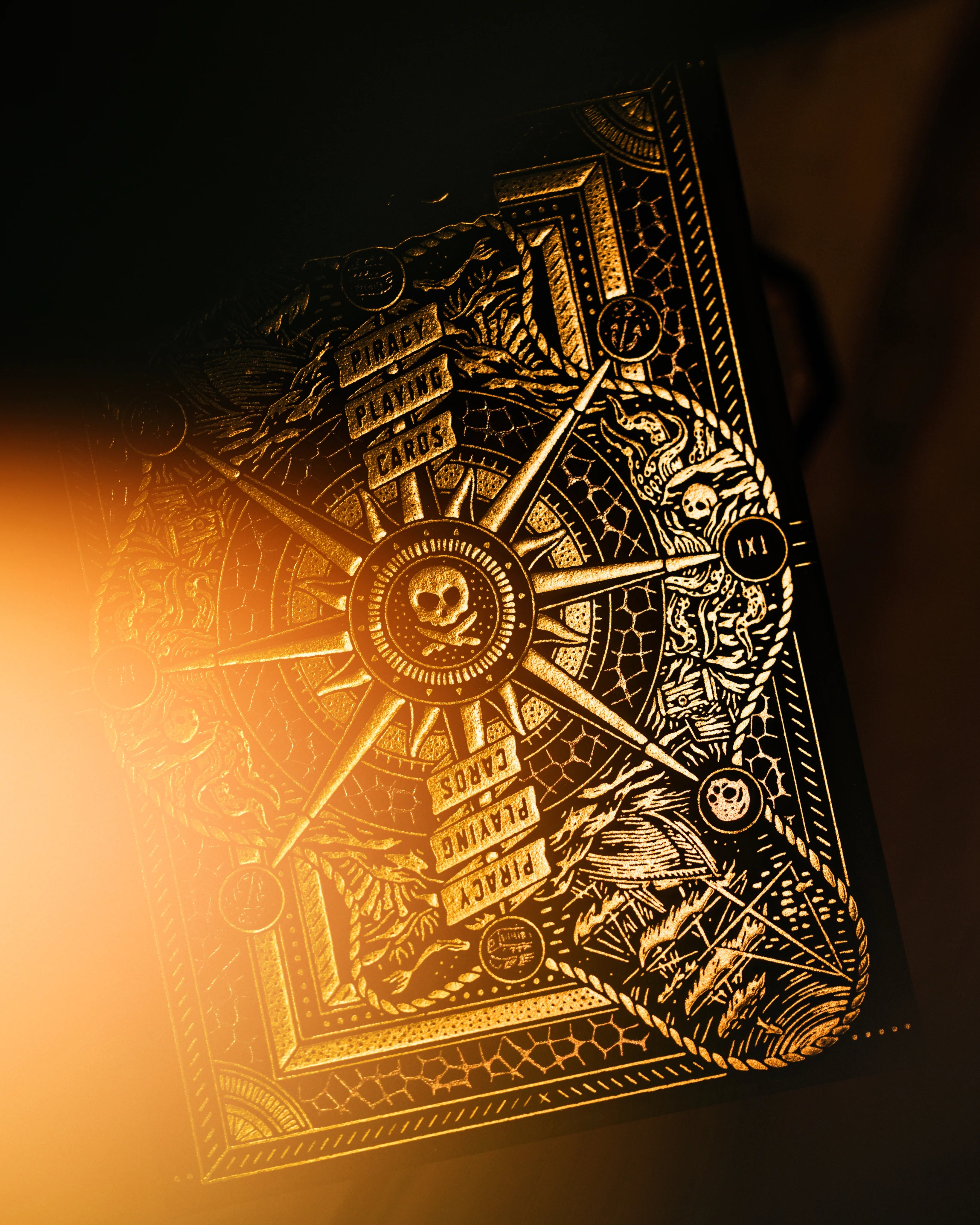 Decorative Piracy deck with intricate gold designs on a dark background
