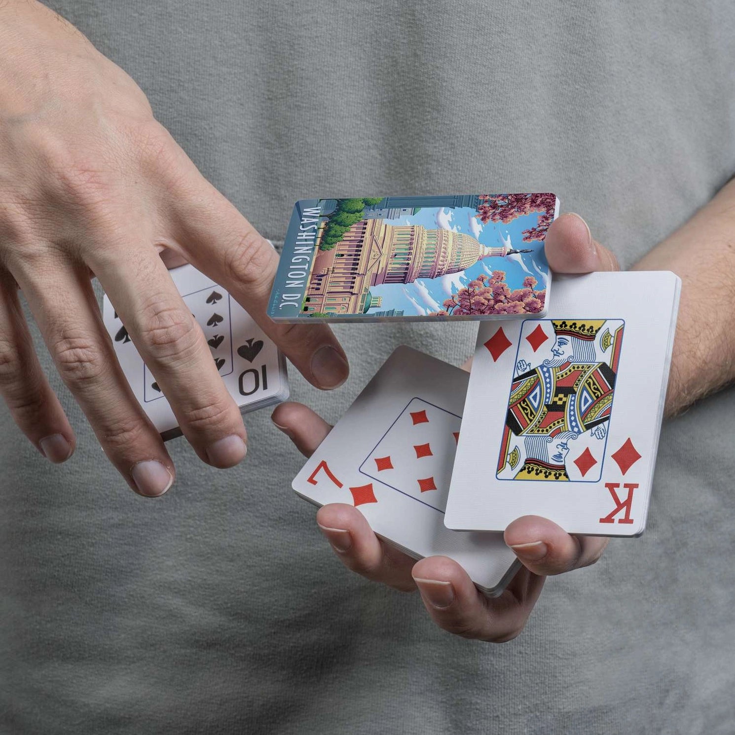 Washington D.C. Boardwalk playing cards handled in a flourish showing Capitol backs and traditional faces