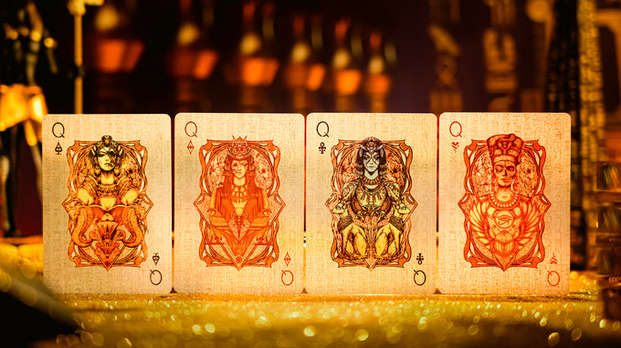 Four Keyhole Luxury Edition playing cards with decorative designs on a blurred background