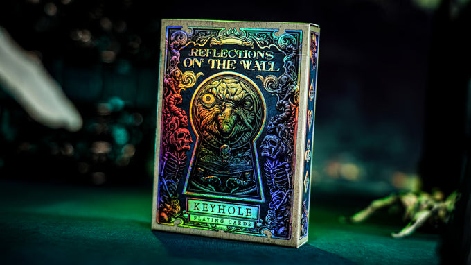 Card deck packaging titled 'Reflections on the Wall' with a keyhole design on a dark background.