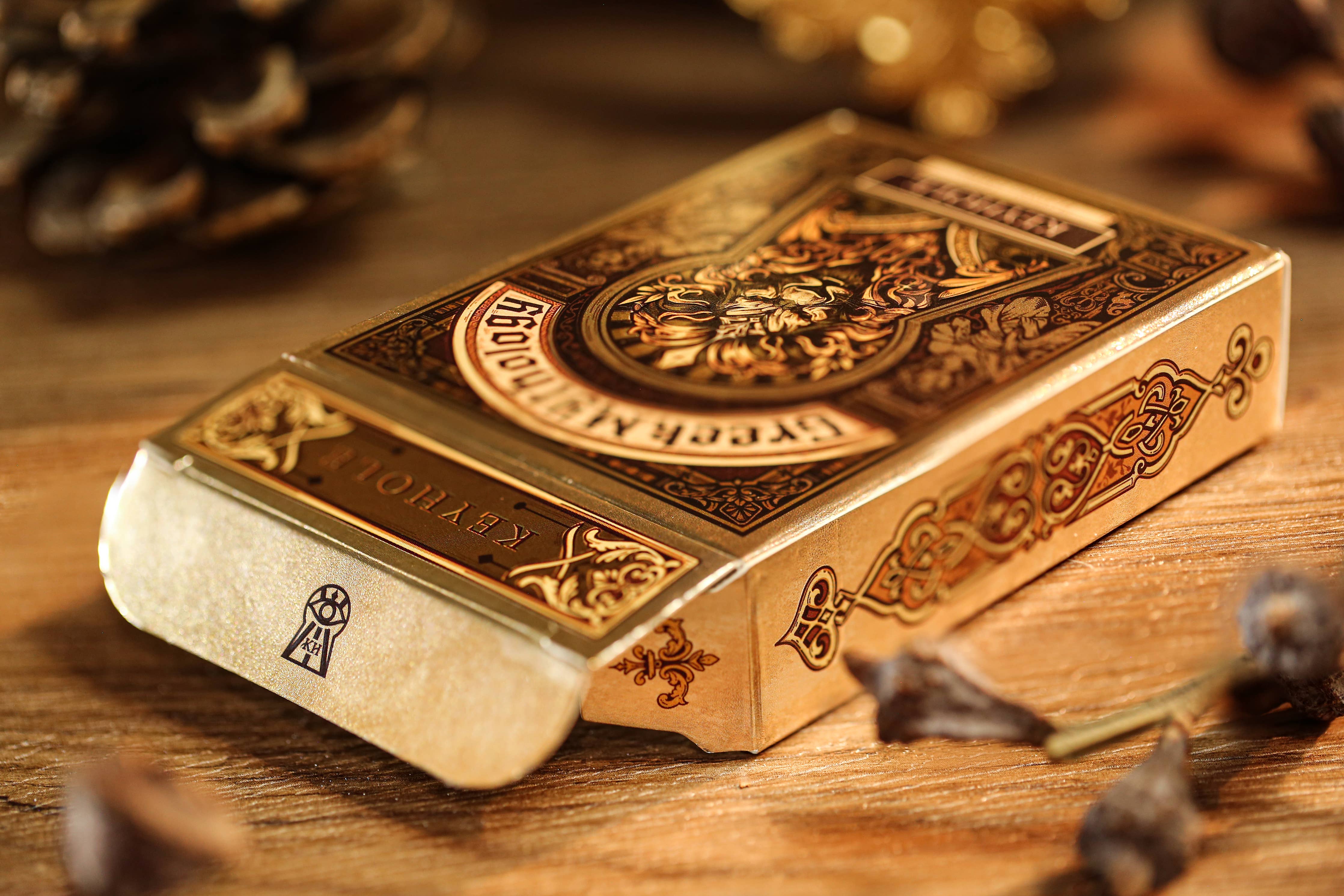 Decorative gold box with intricate designs on a wooden surface