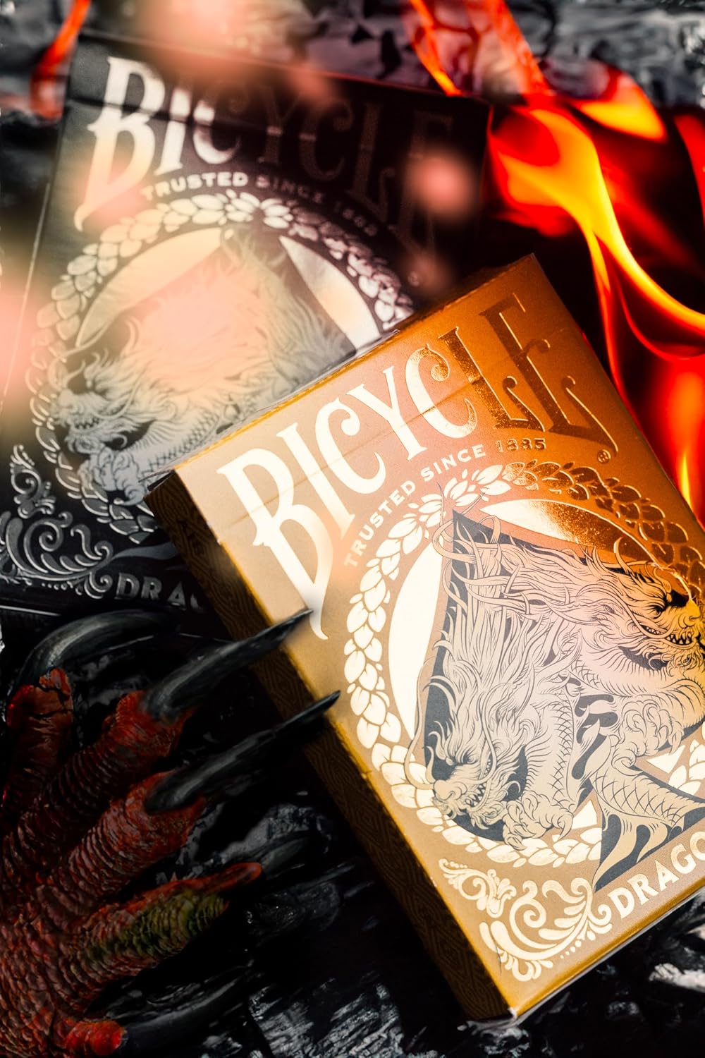 Bicycle Gold Dragon Playing Cards gold-foil tuck box with detailed dragon artwork beside Black Dragon deck