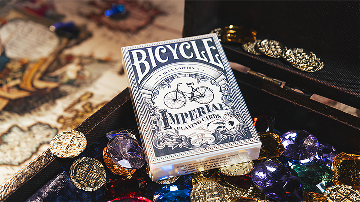 Bicycle Imperial Blue Edition playing cards tuck box displayed among colorful gems