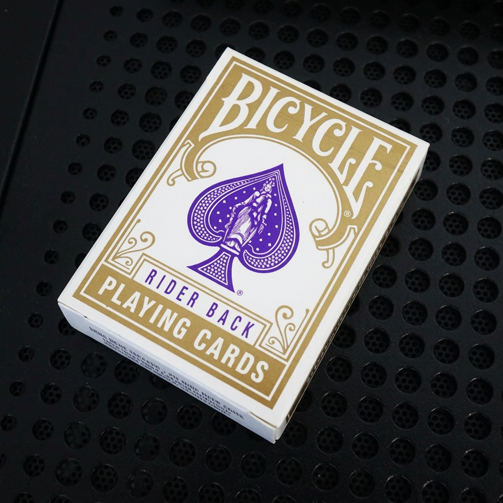 Front of Bicycle Mini Gold Rider Back Playing Cards tuck box with gold Bicycle branding and purple spade emblem