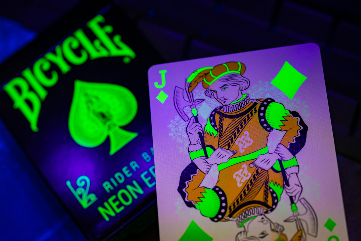 Bicycle Neon Green-Glo tuck box and Jack of Diamonds under UV blacklight
