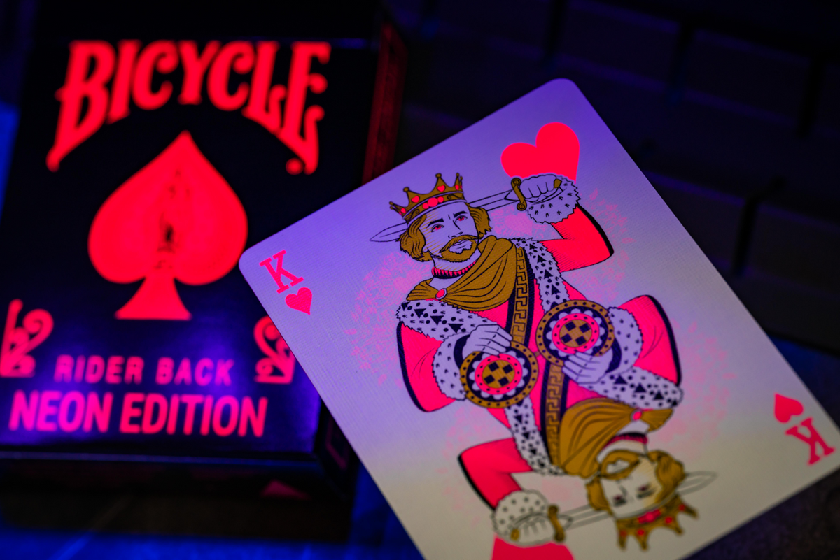 Bicycle Neon Star-Fire Pink tuck box and King of Hearts under UV blacklight