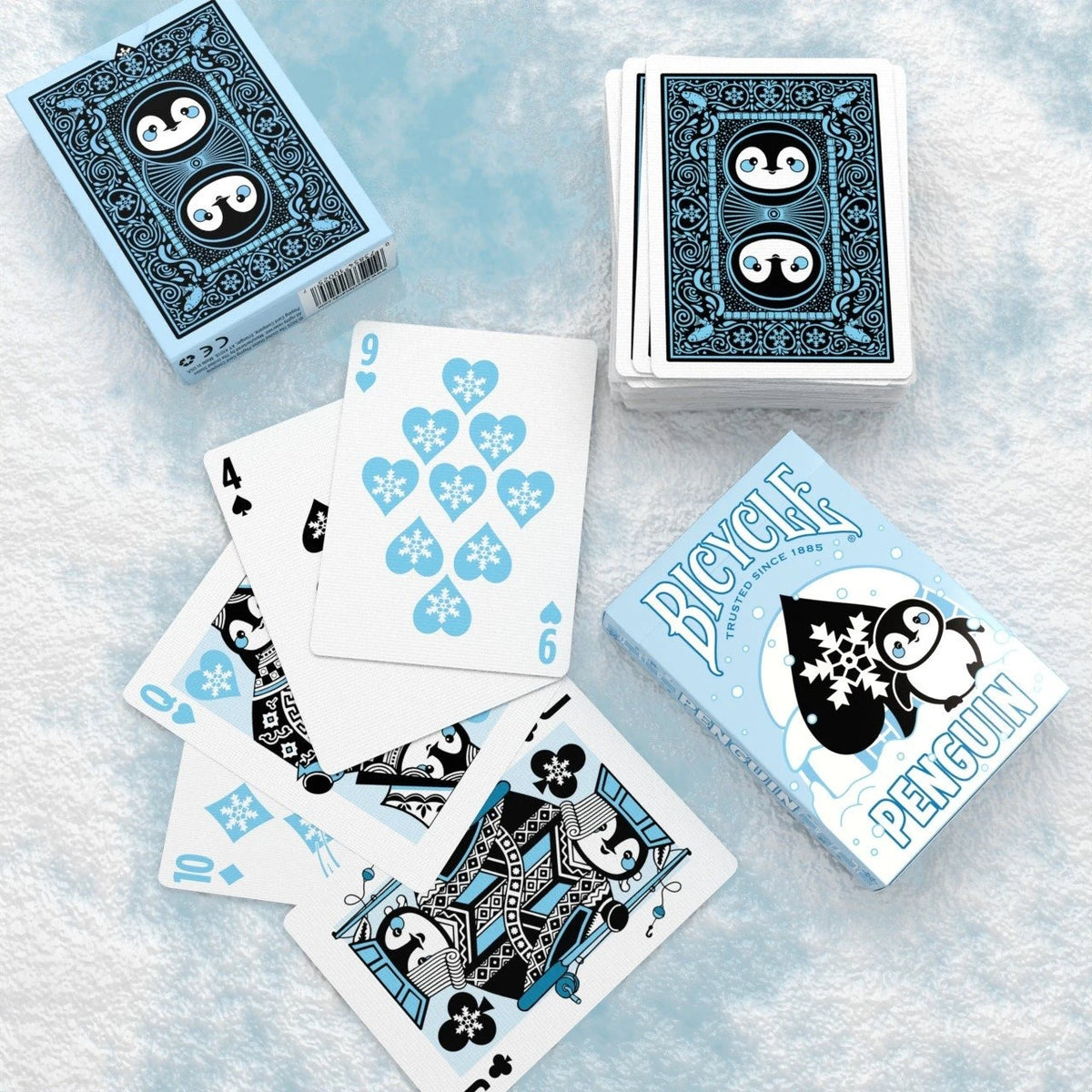 Bicycle Penguin deck with a face-up fan of penguin courts and snowflake number cards beside front and rear tuck-box views