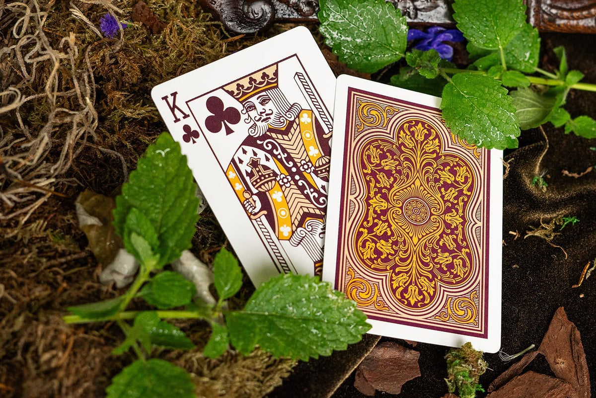 Bicycle Verbena Playing Cards showing burgundy and gold ornamental card back beside King of Clubs