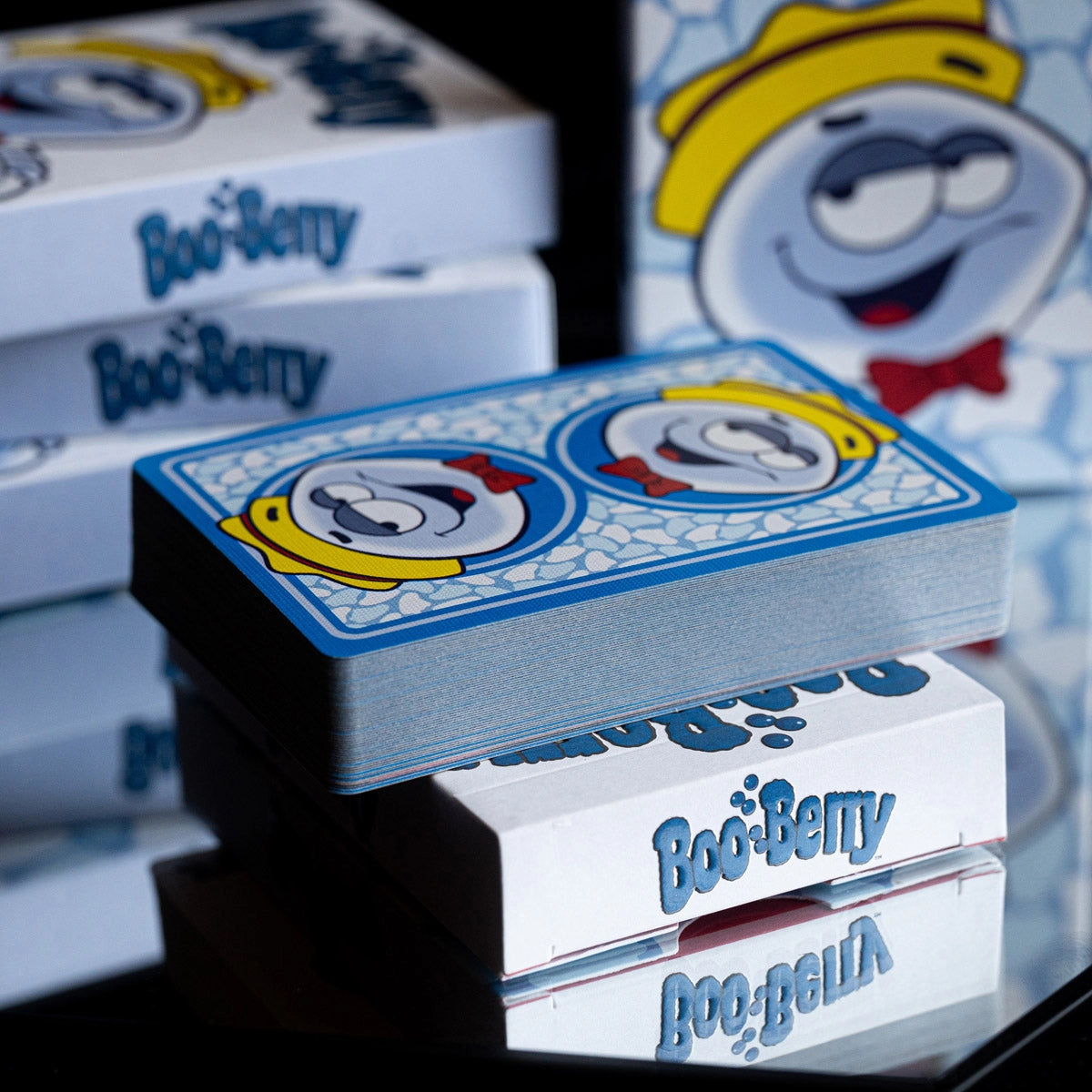 Boo Berry deck resting horizontally on a tuck box with the blue two-way card back visible.