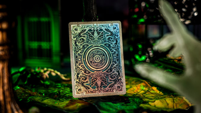 Decorative card with intricate designs held by a hand against a dark, mystical background