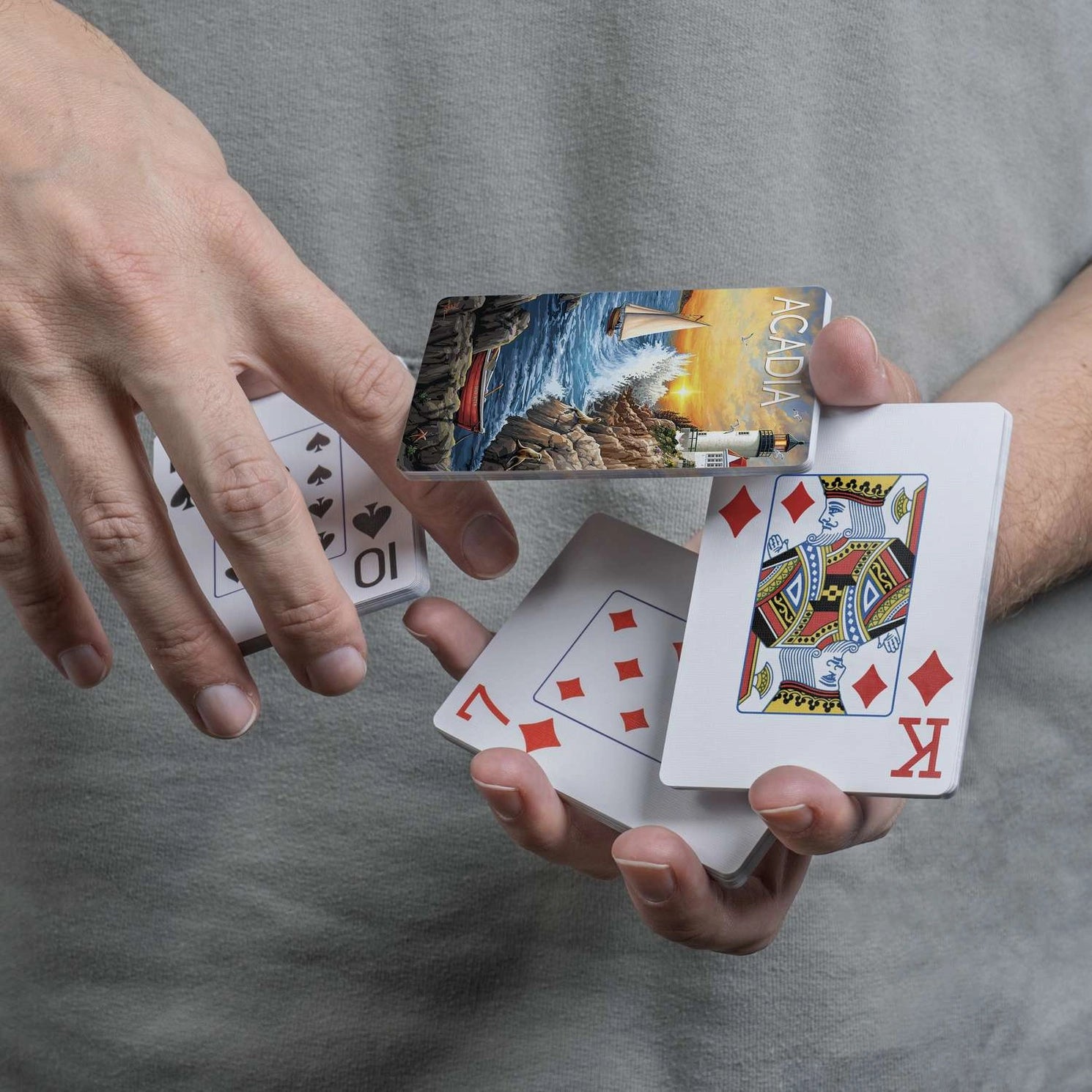 Close-up of Boardwalk Acadia card back and traditional playing-card faces