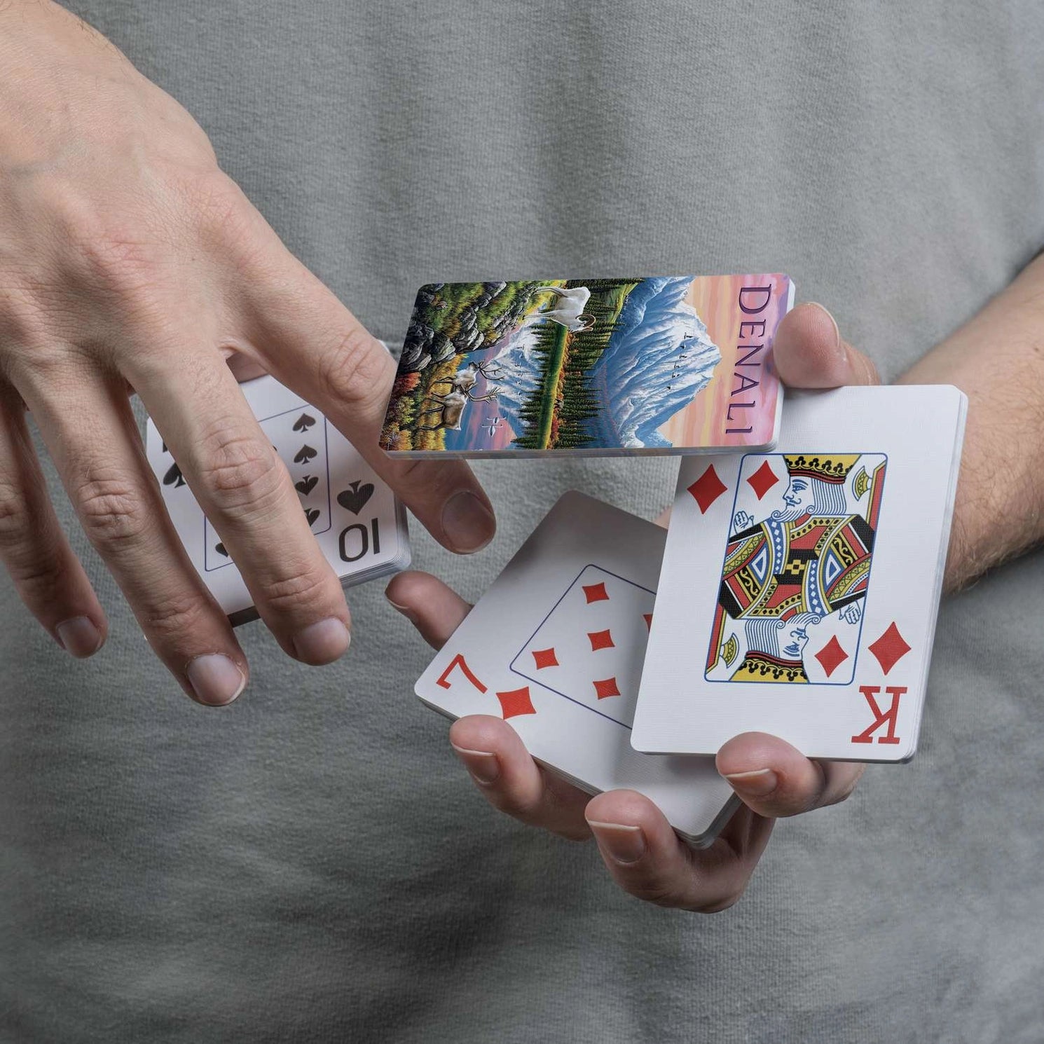 Denali scenic card back displayed during a flourish with traditional playing-card faces