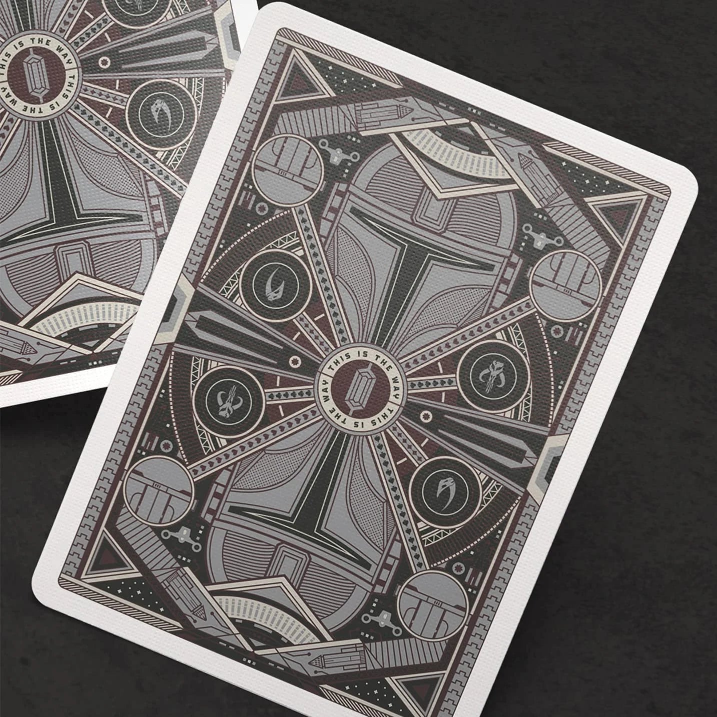 Playing cards with intricate designs on a dark background