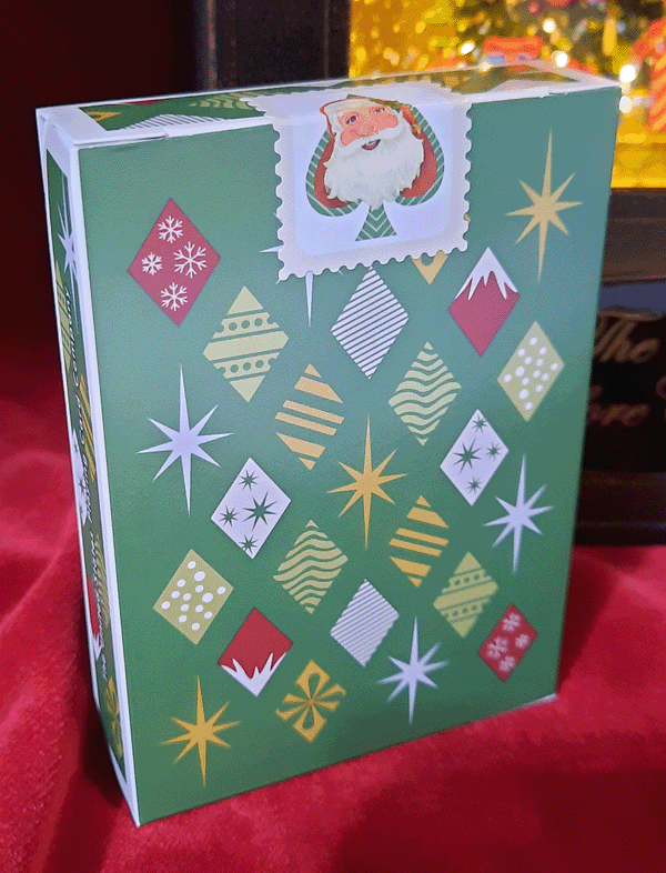 Green gift box with geometric patterns and a Santa Claus illustration on a red background