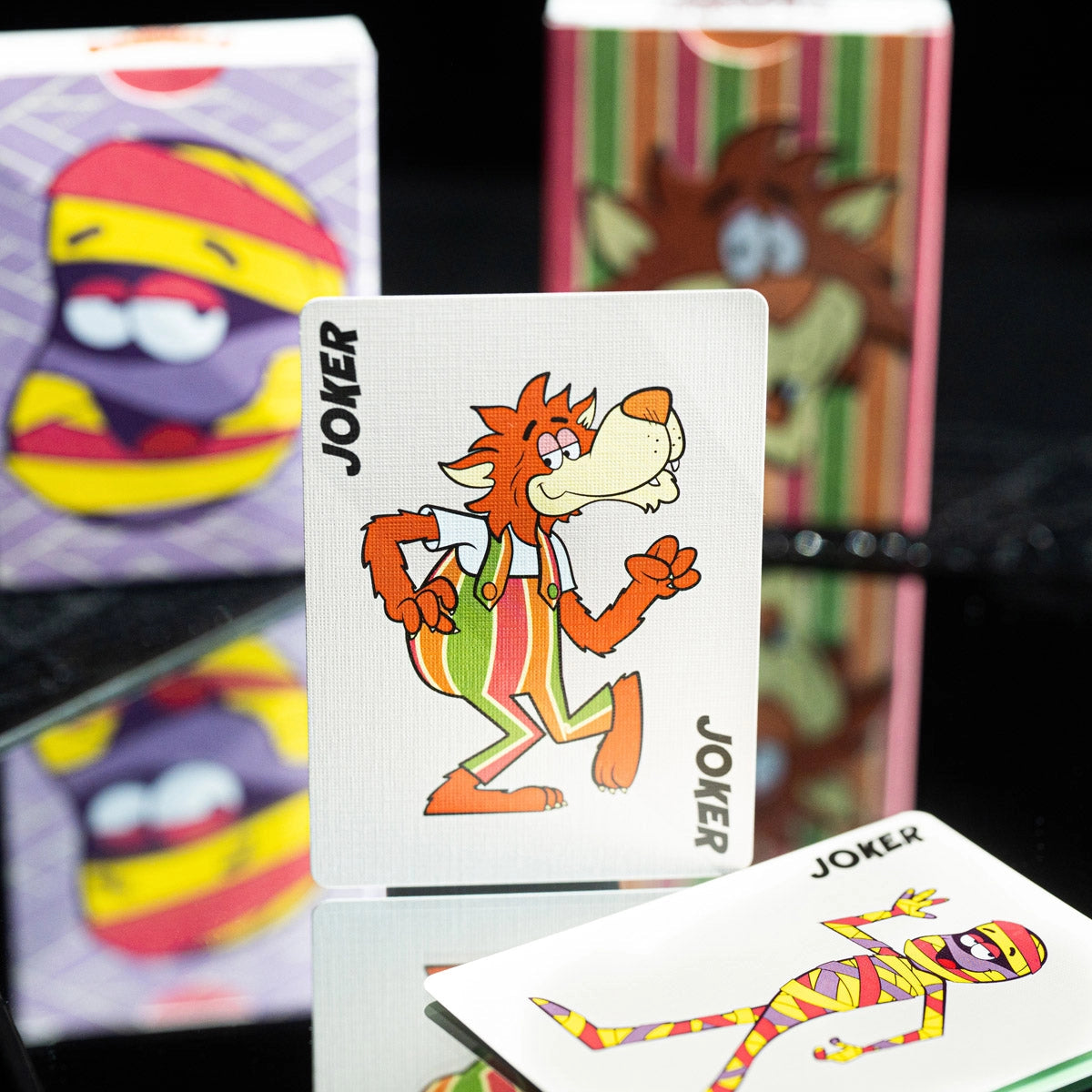 Frute Brute Joker standing upright with the Yummy Mummy Joker lying in front.