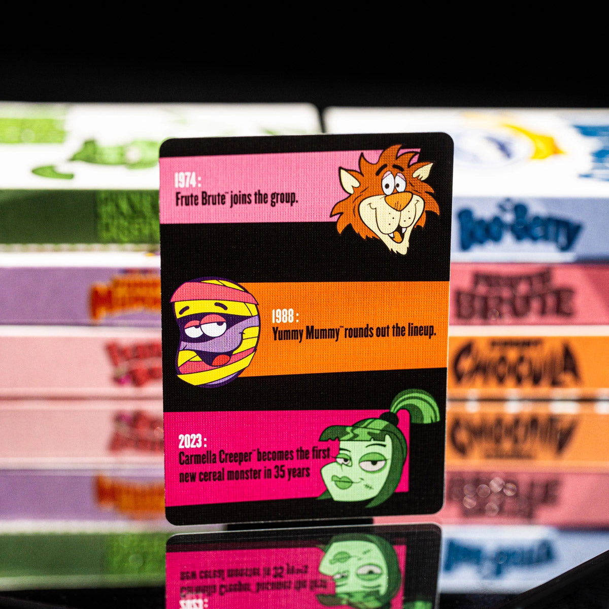 Monster Cereals history card with dated entries and illustrations of Frute Brute, Yummy Mummy, and Carmella Creeper.