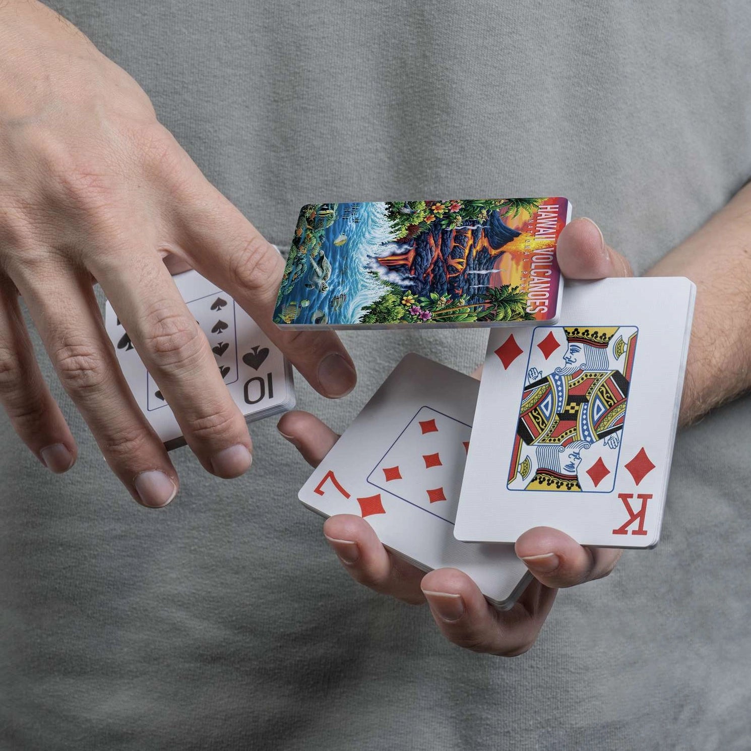 Hawai'i Volcanoes scenic card back displayed during a flourish with traditional playing-card faces
