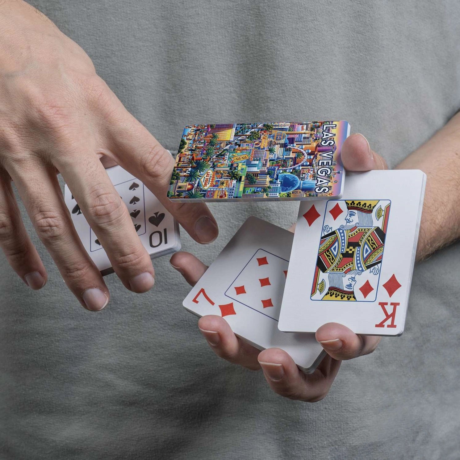 Las Vegas Strip scenic card back displayed during a flourish with traditional playing-card faces