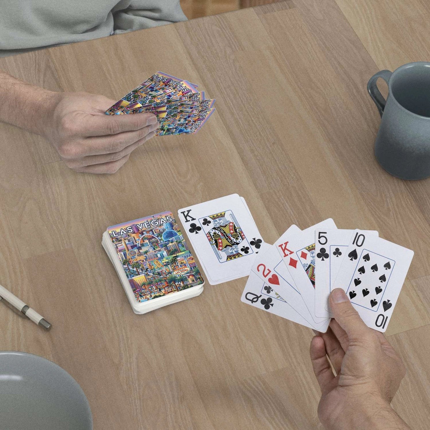 Las Vegas Strip jumbo-index playing cards in use at a table with scenic Vegas card backs