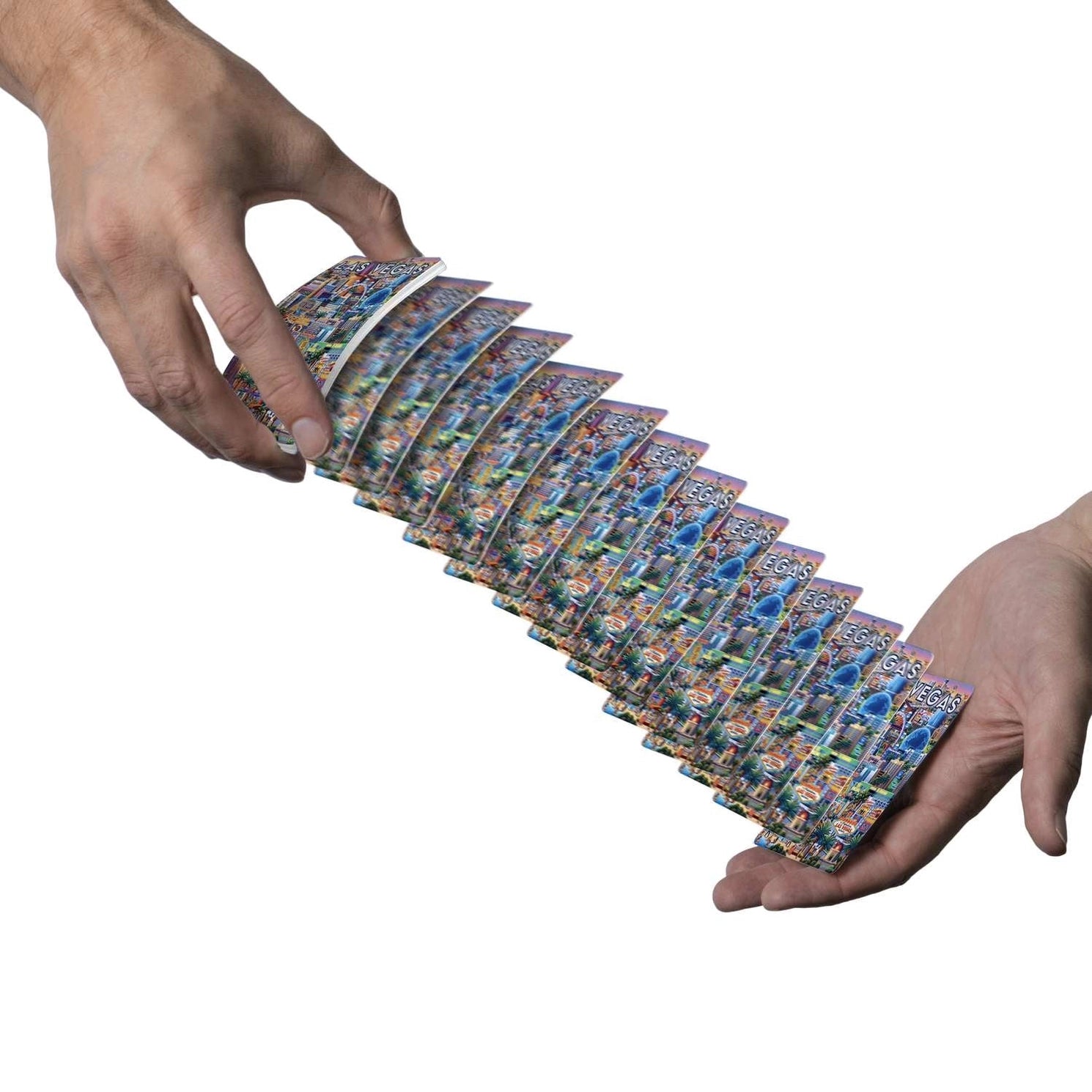 Las Vegas playing cards cascading between two hands with colorful Strip backs visible