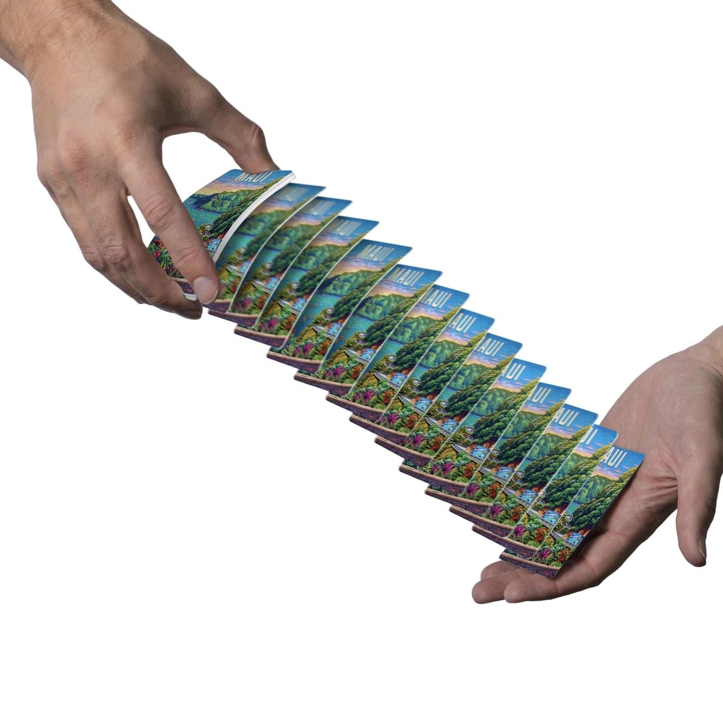Maui Road to Hana Boardwalk playing cards cascading between two hands with tropical scenic backs visible