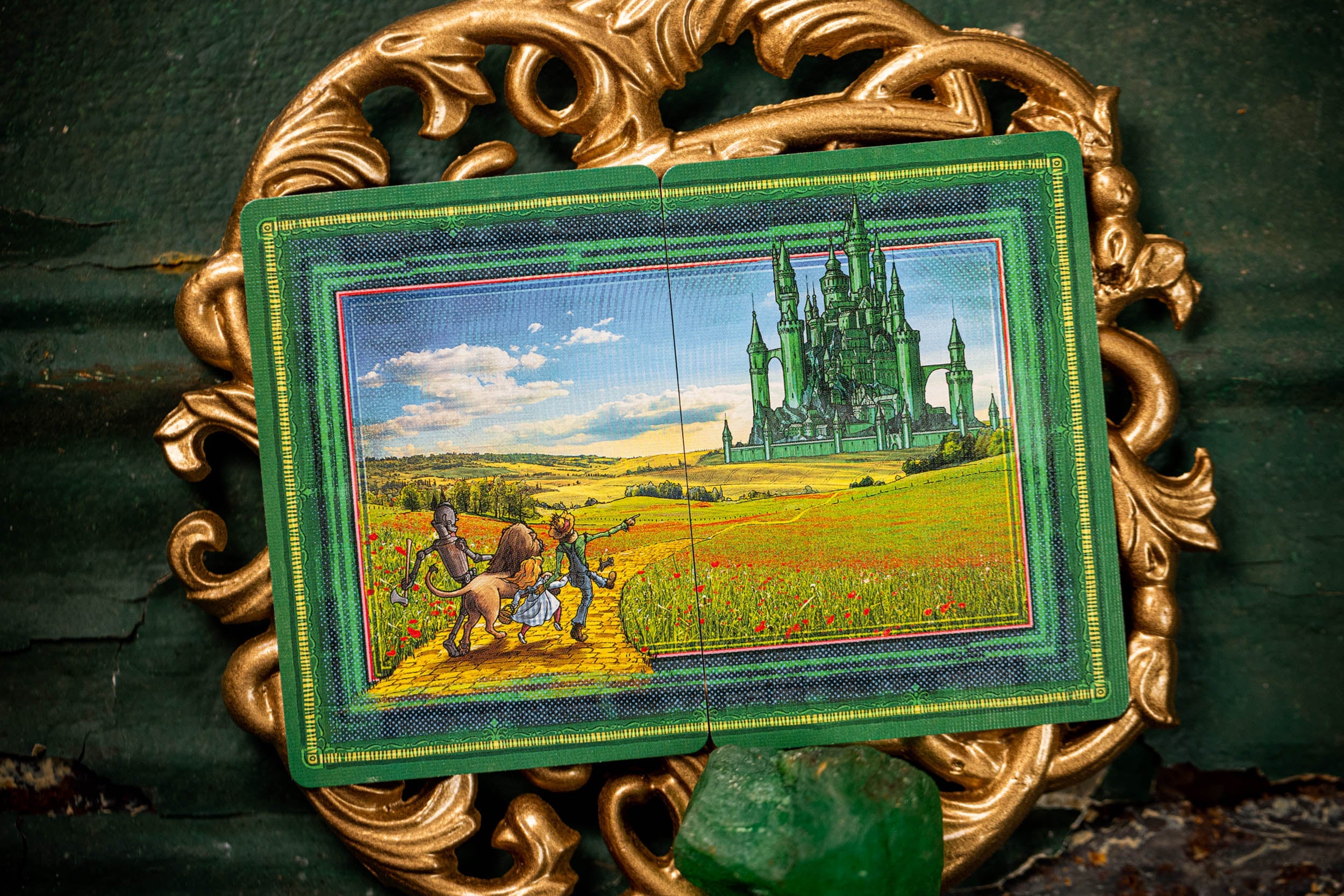 Decorative tile with a castle scene in a gold frame on a textured surface