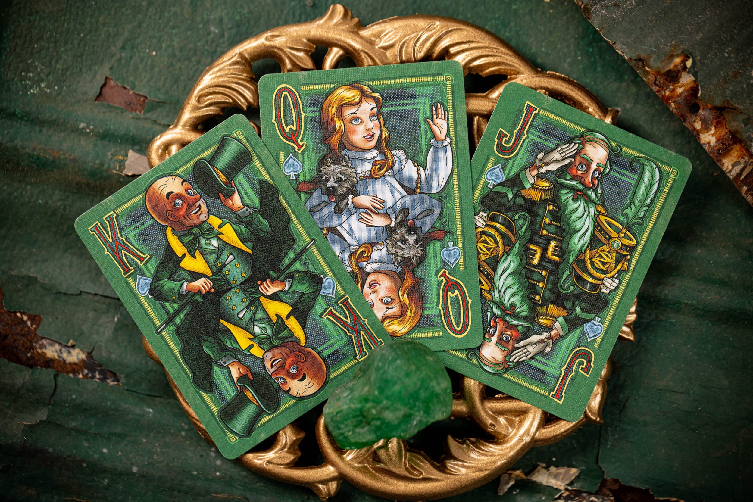 Close-up of vintage playing cards with colorful illustrations on a textured surface.