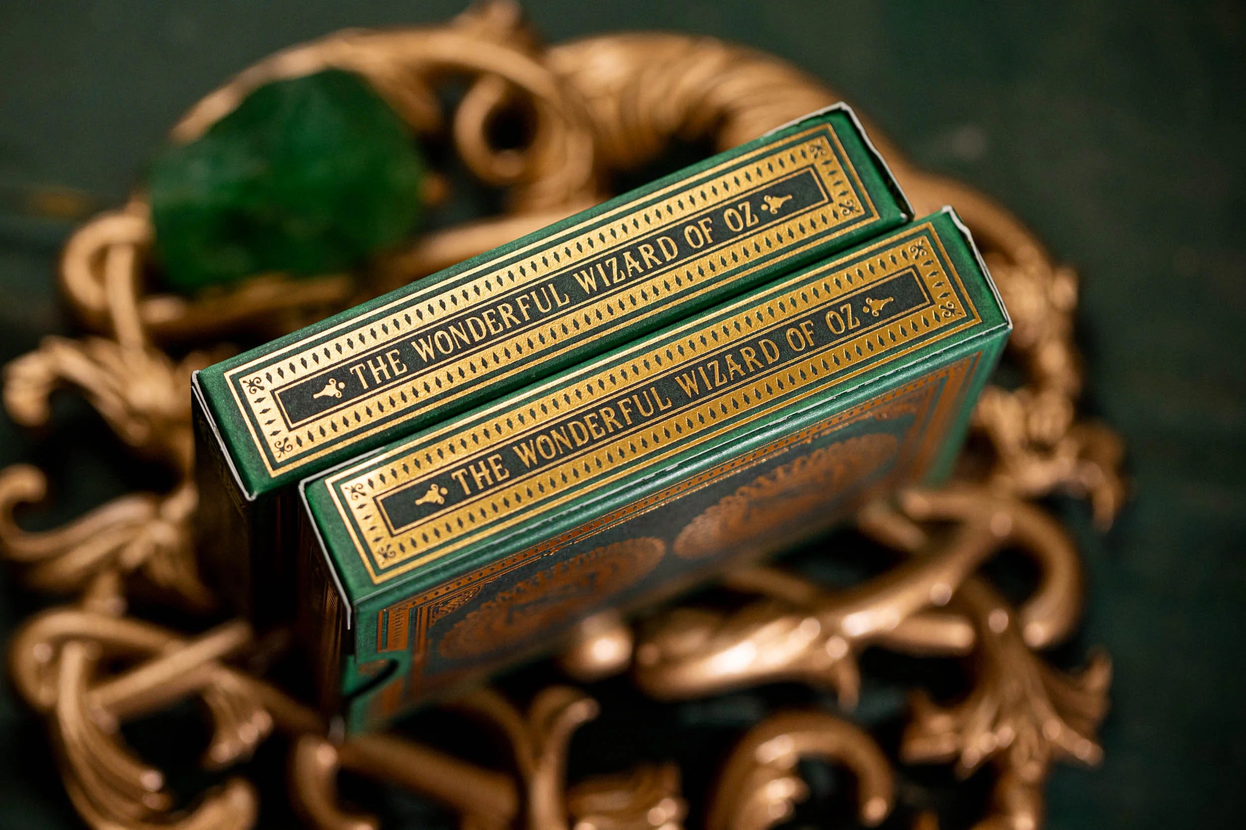 Two green books titled 'The Wonderful Wizard of Oz' on a decorative background