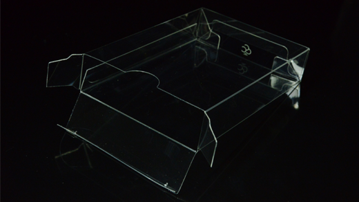 Clear acrylic display stand on a black background