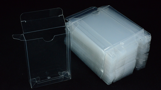 Stack of clear plastic sheets with a holder on a black background