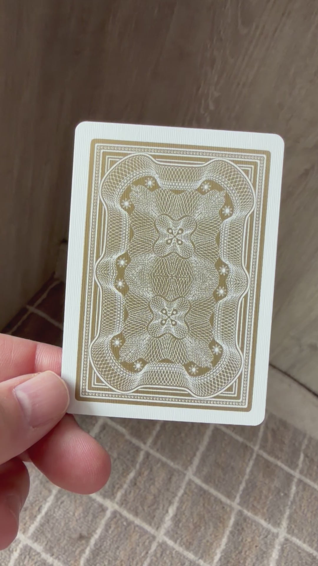 Aristocrat 727 Gold 110th Anniversary card back held in hand on wooden surface