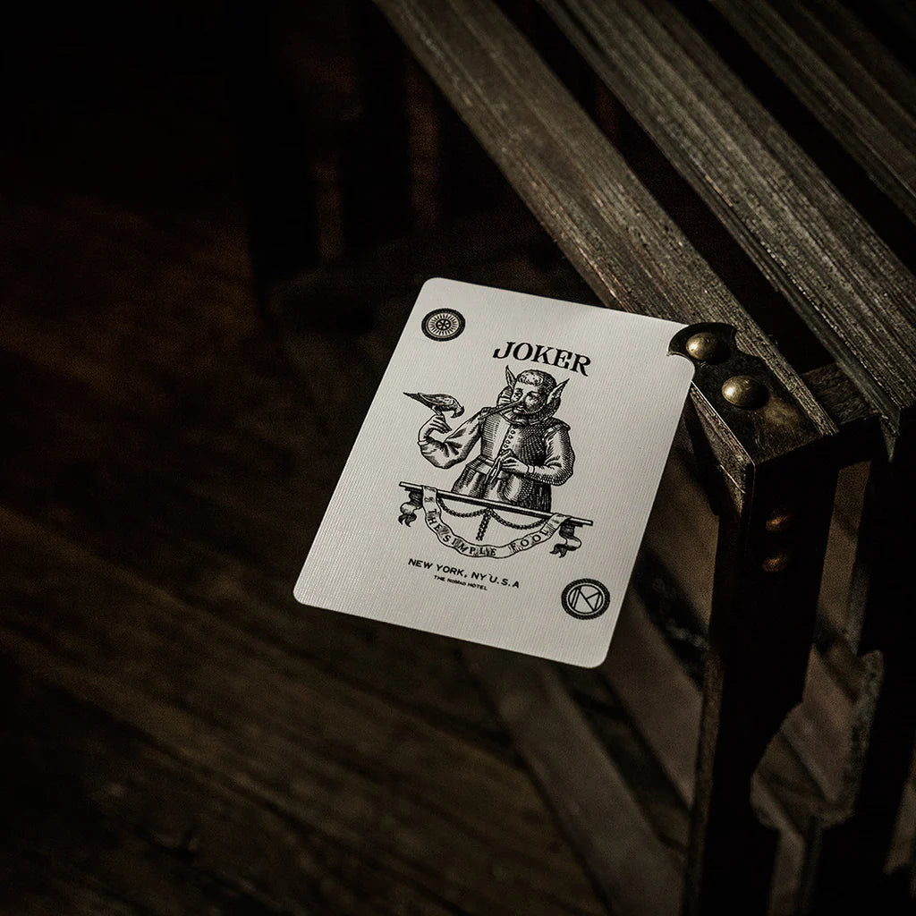Joker card on a wooden surface with a dark background