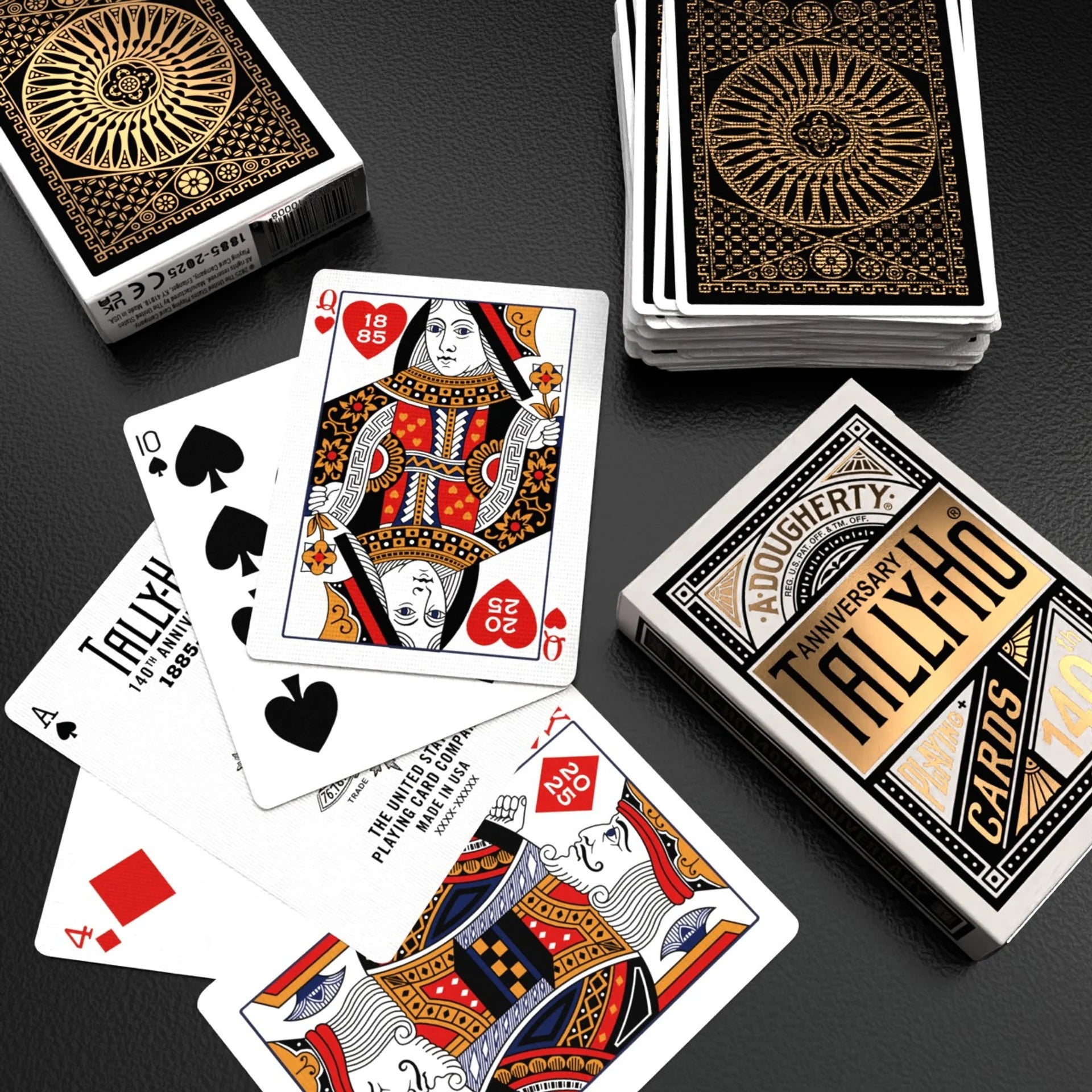 Tally-Ho 140th Anniversary playing cards with decorative packaging on a dark surface