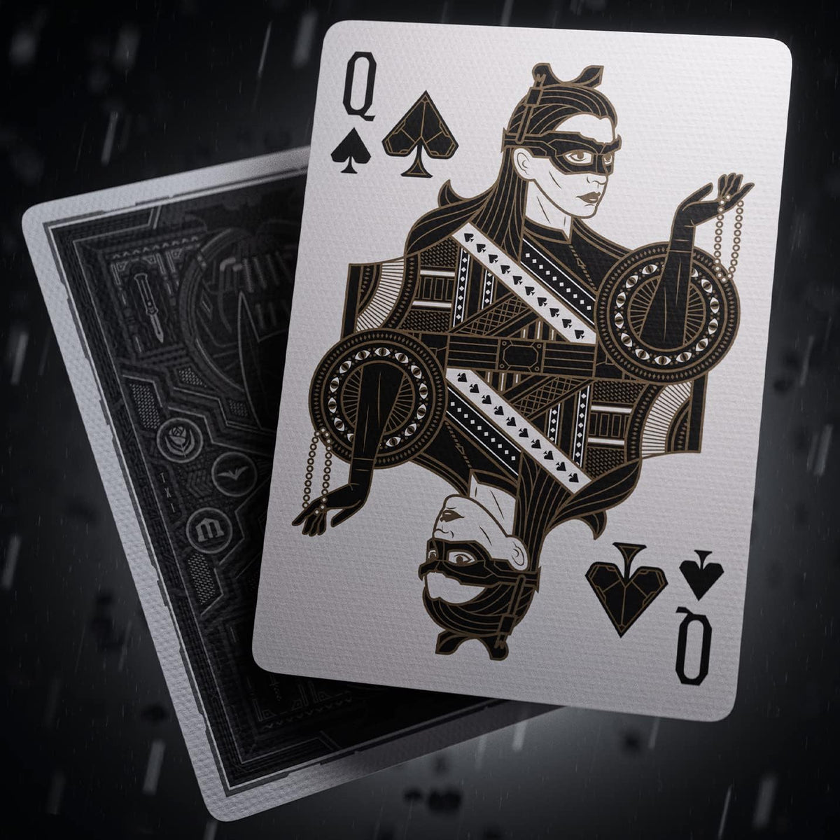 Catwoman as the Queen of Spades in theory11 The Dark Knight Playing Cards, with a patterned card back behind her.