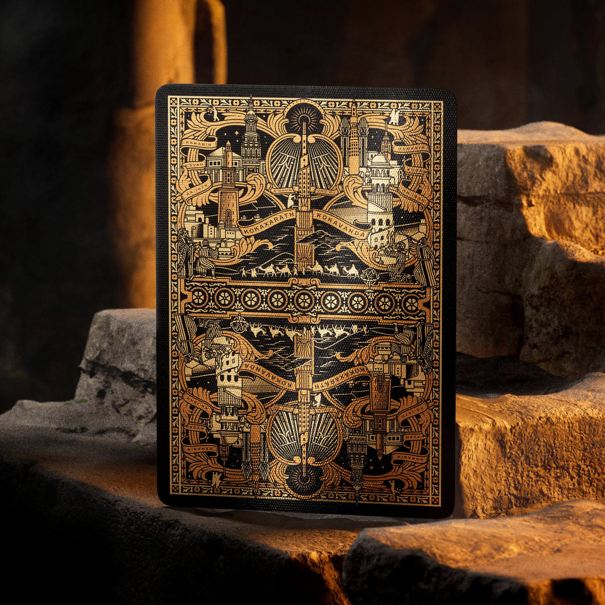 Theory11 Kovadrin card back with mirrored towers, banners, and intricate gold-colored foil artwork against black.