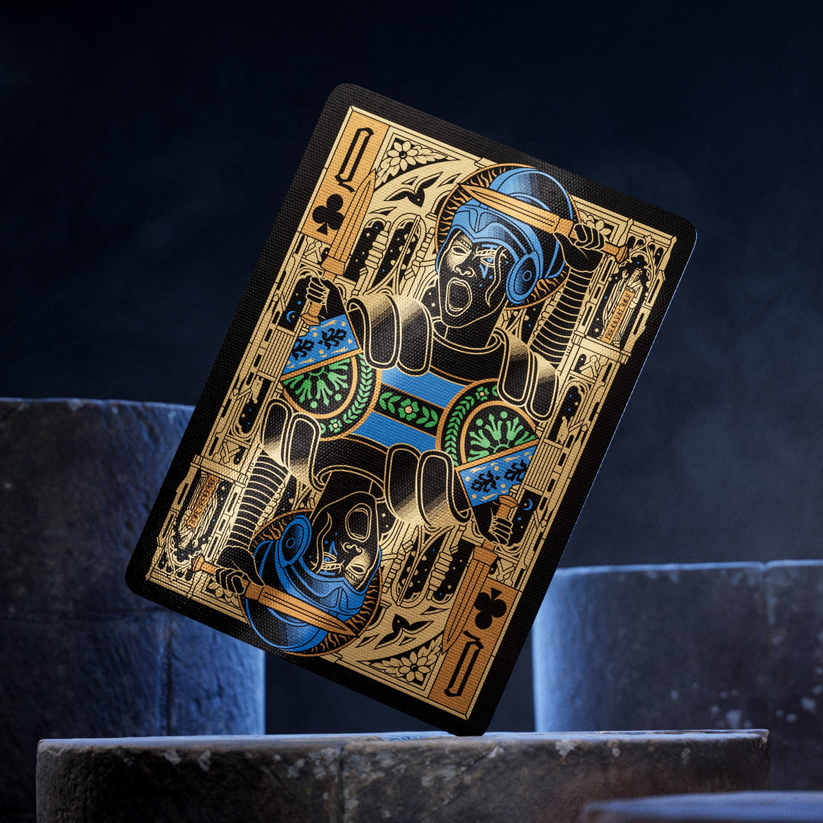 Theory11 Kovadrin Queen of Clubs with a blue helmet, green-and-blue armor, and mirrored gold-and-black artwork.