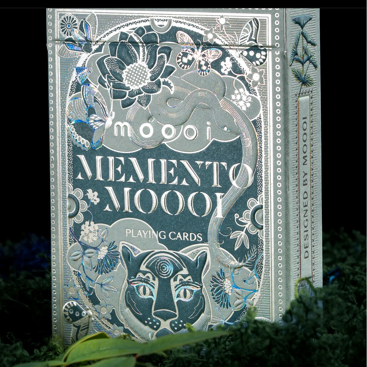 Memento Moooi tuck-box front with reflective animal and floral details beside the Designed by Moooi side panel.