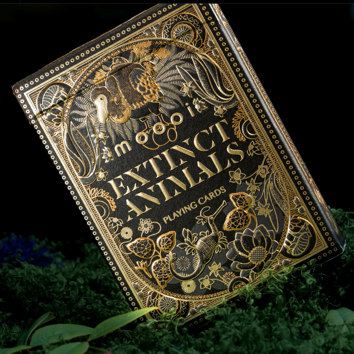 Angled Moooi Extinct Animals tuck box with a gold foil dodo, curling creature, and flowers against black.