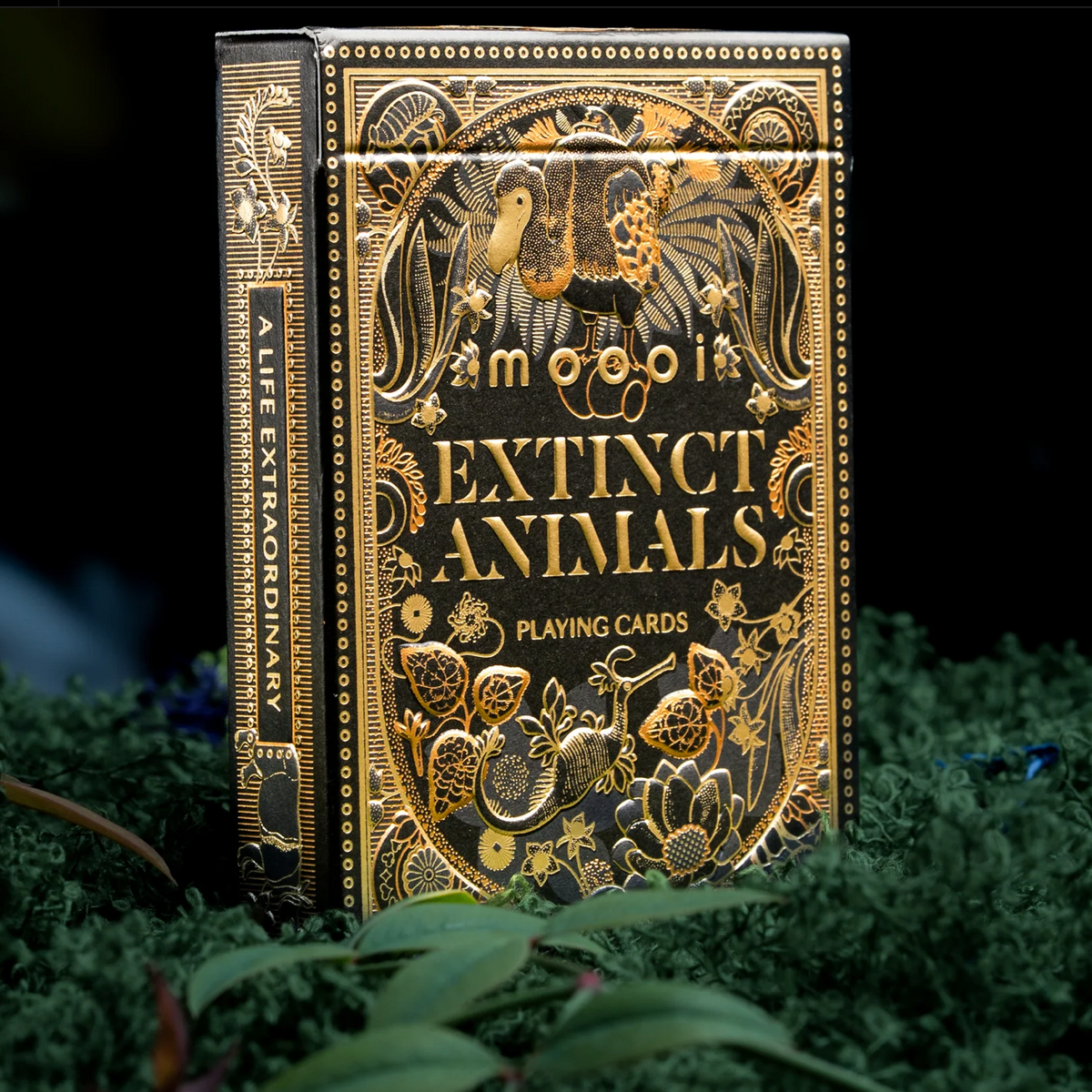 Moooi Extinct Animals tuck-box front and left side showing gold foil details and A Life Extraordinary lettering.