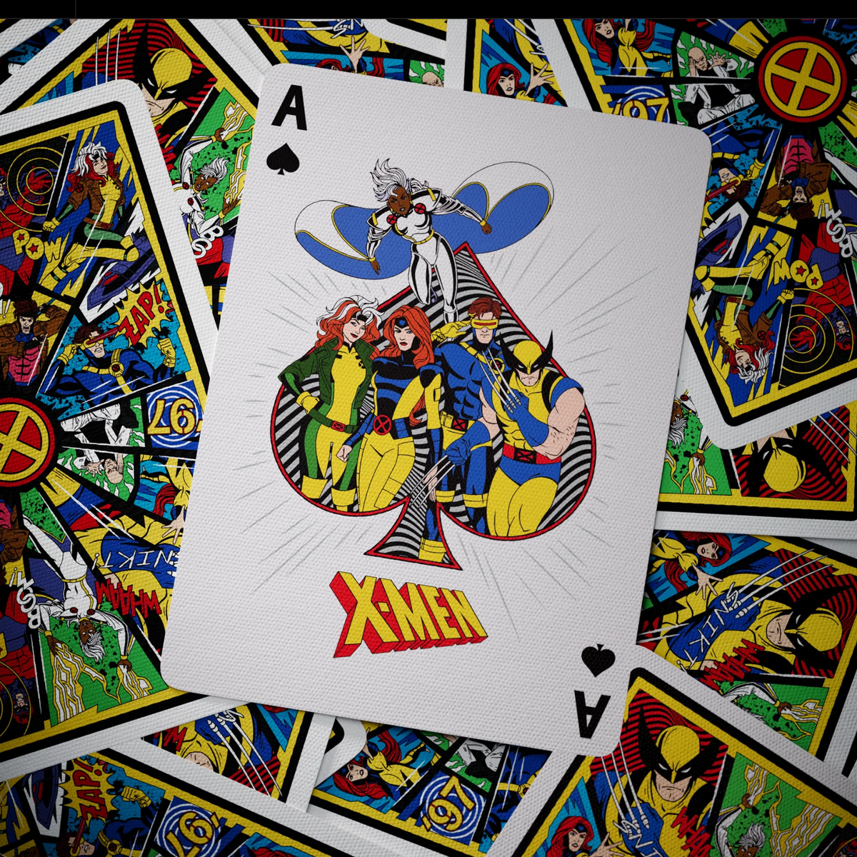 Theory11 X-Men Ace of Spades featuring Storm, Rogue, Jean Grey, Cyclops, and Wolverine over scattered card backs.